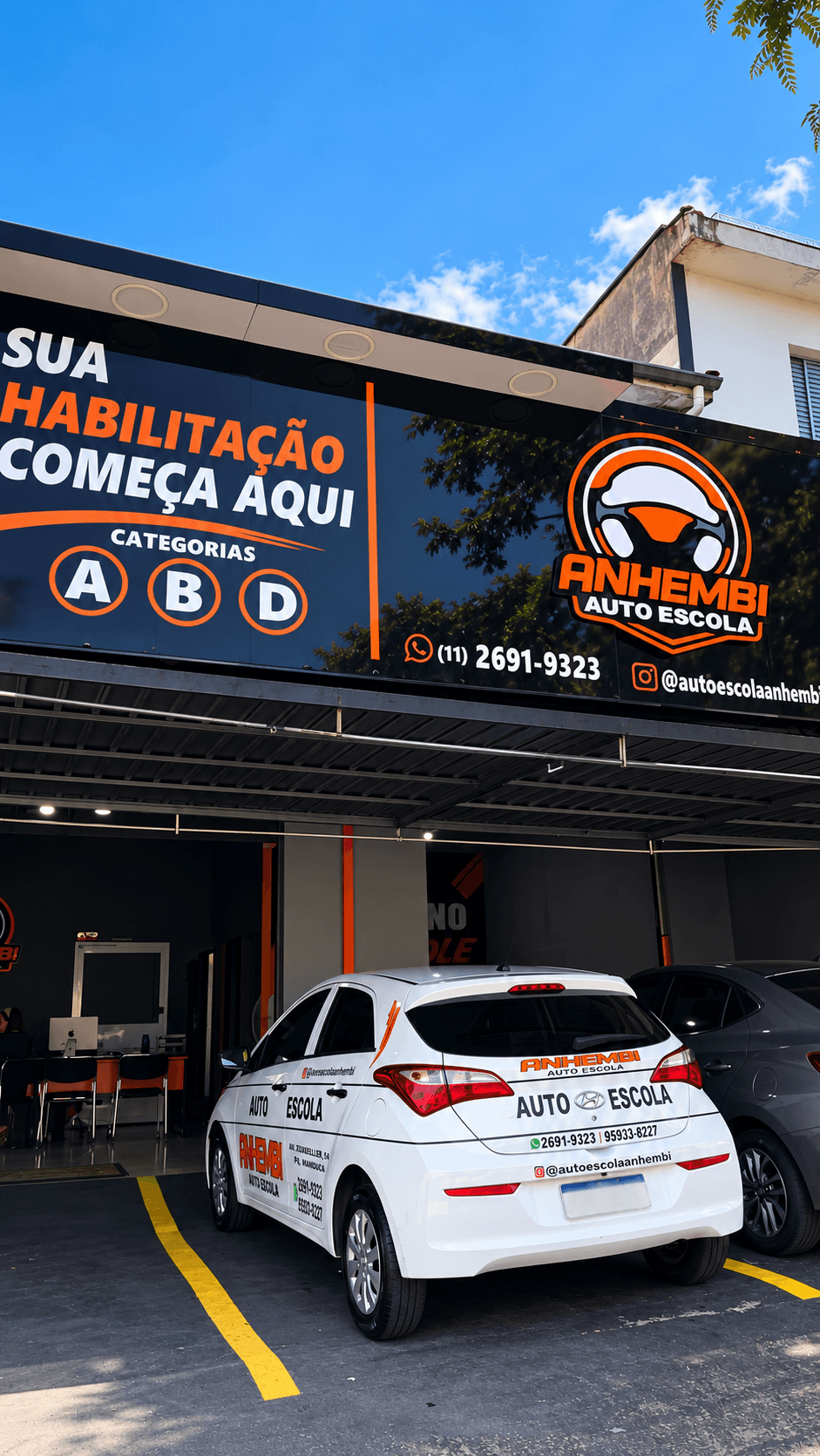 Fachada da Anhembi Auto Escola, no Parque Mandaqui, com um dos carros da frota na frente